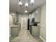Modern kitchen with gray cabinets, granite countertops, and stainless steel appliances at 3011 Hemingway Cir # 3011, Haines City, FL 33844