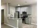 Modern kitchen with gray cabinets, granite countertops, and stainless steel appliances at 3011 Hemingway Cir # 3011, Haines City, FL 33844