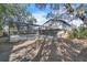 An exterior view of the home showcases a screened pool area and lush greenery at 3020 Rockingham Cir, Orlando, FL 32808