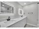 Bathroom featuring dual vanities with illuminated mirrors and walk-in shower at 3020 Rockingham Cir, Orlando, FL 32808