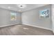 Clean bedroom featuring luxury vinyl plank flooring, ceiling fan, and natural light at 3020 Rockingham Cir, Orlando, FL 32808