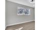 Bright bedroom with light grey walls, ceiling fan, and large window overlooking trees at 3020 Rockingham Cir, Orlando, FL 32808