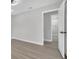 Neutrally decorated bedroom with greige luxury vinyl plank and view to bathroom at 3020 Rockingham Cir, Orlando, FL 32808