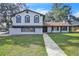 Two-story home with a well-manicured front yard and a patterned walkway leading to the front door at 3020 Rockingham Cir, Orlando, FL 32808