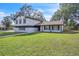 Charming two-story home featuring a large, well-maintained lawn at 3020 Rockingham Cir, Orlando, FL 32808