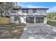 Attached two-car garage with concrete driveway and freshly painted exterior at 3020 Rockingham Cir, Orlando, FL 32808