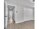 Hallway with closets, doorway, and neutral paint at 3020 Rockingham Cir, Orlando, FL 32808