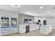 Bright kitchen with white cabinets, modern backsplash, stainless steel appliances, and an island overlooking the pool at 3020 Rockingham Cir, Orlando, FL 32808