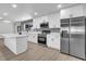Updated kitchen features white cabinets, stainless steel appliances, island and stone backsplash at 3020 Rockingham Cir, Orlando, FL 32808