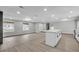 Open-concept living space with fireplace, connecting kitchen area, and natural light from large windows at 3020 Rockingham Cir, Orlando, FL 32808