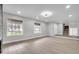 Bright living area with hardwood flooring, large windows, and staircase at 3020 Rockingham Cir, Orlando, FL 32808