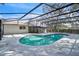Backyard pool featuring turquoise water, screen enclosure, and views of the home at 3020 Rockingham Cir, Orlando, FL 32808