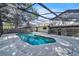 Backyard pool featuring turquoise water, screen enclosure, and mature landscaping at 3020 Rockingham Cir, Orlando, FL 32808