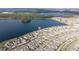 Aerial view showcasing a lakefront home and surrounding neighborhood at 3052 Ella Way, Saint Cloud, FL 34771