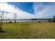 Landscaped backyard with a lake view at 3052 Ella Way, Saint Cloud, FL 34771