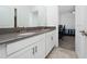 Double vanity bathroom with a view into a bedroom at 3052 Ella Way, Saint Cloud, FL 34771