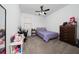 Bedroom with double bed, dresser, and ceiling fan at 3052 Ella Way, Saint Cloud, FL 34771