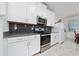 Modern kitchen with stainless steel appliances and dark tile backsplash at 3052 Ella Way, Saint Cloud, FL 34771