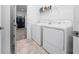 Bright laundry room with washer, dryer and shelving at 3052 Ella Way, Saint Cloud, FL 34771