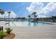 Relaxing community pool with lounge chairs and palm trees at 3052 Ella Way, Saint Cloud, FL 34771