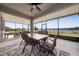 Covered patio overlooking a lake with seating for six at 3052 Ella Way, Saint Cloud, FL 34771