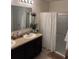 Double vanity bathroom with updated light fixtures and a shower at 3309 Sonder Dr, Davenport, FL 33896