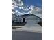 One-story home with two-car garage, landscaping, and a neutral color palette at 3309 Sonder Dr, Davenport, FL 33896