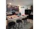 Modern kitchen with dark cabinets, an island, and mosaic backsplash at 3309 Sonder Dr, Davenport, FL 33896