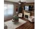 Living room with wood-look floors, a neutral palette, and a rustic fireplace feature at 3309 Sonder Dr, Davenport, FL 33896
