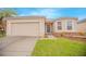 Single-story home with a two-car garage and landscaped lawn at 3643 Julius Estates Blvd, Winter Haven, FL 33881