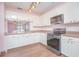 Modern kitchen with stainless steel appliances and light cabinets at 3643 Julius Estates Blvd, Winter Haven, FL 33881