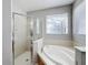 Bathroom with shower, soaking tub and window at 370 Henley Cir, Davenport, FL 33896