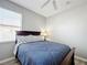 Cozy bedroom with a full bed, ceiling fan, and window coverings at 370 Henley Cir, Davenport, FL 33896