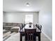 Dining area with dark wood table and chairs, adjacent to a living room at 370 Henley Cir, Davenport, FL 33896