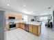 Kitchen with stainless steel appliances and light wood cabinets at 370 Henley Cir, Davenport, FL 33896