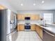 Kitchen featuring stainless steel appliances and light wood cabinets at 370 Henley Cir, Davenport, FL 33896