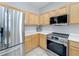 Modern kitchen features stainless steel appliances and light wood cabinets at 370 Henley Cir, Davenport, FL 33896