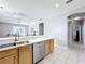 Kitchen with stainless steel appliances and light wood cabinets at 370 Henley Cir, Davenport, FL 33896