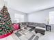 Living room featuring a gray sectional sofa, coffee table, and decorated Christmas tree at 370 Henley Cir, Davenport, FL 33896