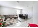 Open living and dining area with gray sectional sofa and wooden dining table at 370 Henley Cir, Davenport, FL 33896