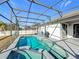 Inviting pool area with screened enclosure, spa, and patio at 370 Henley Cir, Davenport, FL 33896