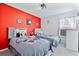 Mickey Mouse themed twin bedroom with red accent wall at 384 Orange Cosmos Blvd, Davenport, FL 33837