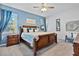 Primary bedroom with king bed, blue walls, and wood furniture at 384 Orange Cosmos Blvd, Davenport, FL 33837