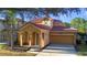 Two-story house with terracotta roof and attached garage at 384 Orange Cosmos Blvd, Davenport, FL 33837