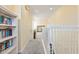 Upstairs hallway with carpeted floors and white railing at 384 Orange Cosmos Blvd, Davenport, FL 33837