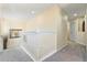 Upstairs hallway with carpeted floors and white railing at 384 Orange Cosmos Blvd, Davenport, FL 33837