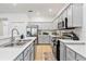 Modern kitchen with stainless steel appliances and white cabinets at 384 Orange Cosmos Blvd, Davenport, FL 33837