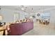 Open living and dining area with a leather couch and tile floors at 384 Orange Cosmos Blvd, Davenport, FL 33837