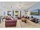 Spacious living room with leather sofas and access to the backyard at 384 Orange Cosmos Blvd, Davenport, FL 33837