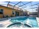 Large screened pool and spa with patio furniture at 384 Orange Cosmos Blvd, Davenport, FL 33837